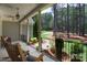 Relaxing front porch with rocking chairs and a view of the lush, wooded yard at 4660 Gold Finch Dr, Denver, NC 28037