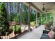 Spacious covered porch with comfortable seating, overlooking the serene, tree-filled surroundings at 4660 Gold Finch Dr, Denver, NC 28037