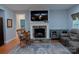 Cozy living room features a stone fireplace with mounted TV and comfortable seating at 4660 Gold Finch Dr, Denver, NC 28037