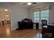 Office space with hardwood flooring, a large window, and access to the dining room at 4660 Gold Finch Dr, Denver, NC 28037