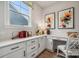 Bright home office featuring custom built-in shelving and drawers, natural light, and modern decor at 5111 Raging Creek Dr, Indian Trail, NC 28079