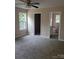 Cozy bedroom with plush carpet, a ceiling fan, and bright windows at 528 S Caldwell St, Salisbury, NC 28144