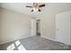 Carpeted bedroom with ceiling fan and neutral walls at 528 S Caldwell St, Salisbury, NC 28144