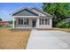 Charming single-story home featuring a covered front porch and a freshly poured concrete driveway at 528 S Caldwell St, Salisbury, NC 28144