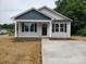 Charming single-story home with gray siding, black shutters, and a well-manicured front yard at 528 S Caldwell St, Salisbury, NC 28144
