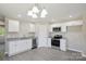 Bright kitchen with white cabinets, stainless steel appliances, and granite countertops at 528 S Caldwell St, Salisbury, NC 28144