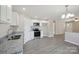 Open kitchen with white cabinets, granite countertops, and stainless steel appliances at 528 S Caldwell St, Salisbury, NC 28144
