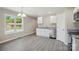 Kitchen featuring white cabinets, stainless steel appliances, granite countertops, and gray flooring at 528 S Caldwell St, Salisbury, NC 28144