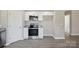 New kitchen featuring white cabinets, granite countertops, and modern stainless steel appliances at 528 S Caldwell St, Salisbury, NC 28144