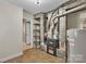 Unfinished basement area with a Goodman furnace, hot water heater, and open shelving for storage at 5633 Mallard S Dr, Charlotte, NC 28227