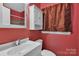 Cozy bathroom featuring a vanity sink, and a framed mirror at 5633 Mallard S Dr, Charlotte, NC 28227