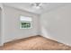 A bright bedroom featuring neutral walls, carpeted floors, and a window with natural light at 5633 Mallard S Dr, Charlotte, NC 28227