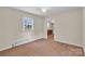 Bedroom featuring a window, neutral walls, and carpeted floors at 5633 Mallard S Dr, Charlotte, NC 28227