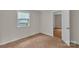 Inviting bedroom with a large window, plush carpeting, and natural light at 5633 Mallard S Dr, Charlotte, NC 28227