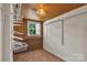Walk-in closet with a window and adjustable white metal shelving and wire basket to maximize storage space at 5633 Mallard S Dr, Charlotte, NC 28227