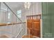 Foyer featuring wood floors, staircase, and chandelier, creating a grand entrance at 5633 Mallard S Dr, Charlotte, NC 28227