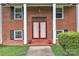 Close up of the red double door front entrance of this charming red brick house at 5633 Mallard S Dr, Charlotte, NC 28227