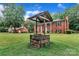 A well in the front yard sits in front of a charming two-story red brick home at 5633 Mallard S Dr, Charlotte, NC 28227