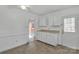 Eat-in kitchen featuring white cabinets, neutral countertops, and ample storage at 5633 Mallard S Dr, Charlotte, NC 28227
