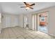 Bright living room featuring tile floors and glass doors opening to a fenced yard at 5633 Mallard S Dr, Charlotte, NC 28227