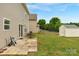 Spacious backyard including a patio set and a storage shed surrounded by a lush lawn at 6104 Follow The Trl, Indian Trail, NC 28079