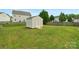 Backyard features a storage shed on a well-kept lawn with partial fencing and some trees at 6104 Follow The Trl, Indian Trail, NC 28079