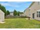 Well-kept backyard features an expansive lawn, a storage shed, and a patio set near the house at 6104 Follow The Trl, Indian Trail, NC 28079