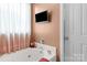An elegant soaking tub features a mounted TV in this Primary bathroom at 6104 Follow The Trl, Indian Trail, NC 28079
