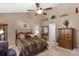 A bedroom features a fan, high ceilings, and a view into the Primary bathroom at 6104 Follow The Trl, Indian Trail, NC 28079