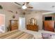 A bedroom with high ceilings features multiple dressers, an ensuite bathroom, and a TV at 6104 Follow The Trl, Indian Trail, NC 28079