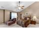 A Primary bedroom features a fan, a chaise lounge, and an ensuite bathroom at 6104 Follow The Trl, Indian Trail, NC 28079