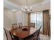Formal dining room with a wooden table, six chairs, and a decorative chandelier at 6104 Follow The Trl, Indian Trail, NC 28079
