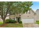 Charming two-story home features a well-manicured lawn, mature trees, and a two-car garage at 6104 Follow The Trl, Indian Trail, NC 28079