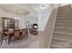 An open-concept living space features a dining area, living room and stairway at 6104 Follow The Trl, Indian Trail, NC 28079