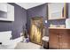 Small powder room with grey walls, a vanity, a framed picture, and a tiled floor at 634 E Center Ave, Mooresville, NC 28115