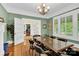 Stylish dining room featuring hardwood floors, a modern chandelier, and ample natural light at 634 E Center Ave, Mooresville, NC 28115