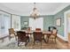 Elegant dining room with a large chandelier, hardwood floors, and classic moldings at 634 E Center Ave, Mooresville, NC 28115