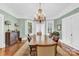 Bright dining room with hardwood floors, a decorative chandelier, and white-trimmed windows at 634 E Center Ave, Mooresville, NC 28115