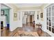 Welcoming foyer featuring hardwood floors, wainscoting, staircase, and classic architectural details at 634 E Center Ave, Mooresville, NC 28115