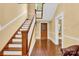 Entryway showcases a wooden staircase, hardwood floors, and a decorative front door at 634 E Center Ave, Mooresville, NC 28115