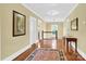 Bright hallway with hardwood floors, neutral walls, and views of the staircase at 634 E Center Ave, Mooresville, NC 28115