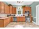 Traditional kitchen with wooden cabinets, stainless appliances, and tiled floors at 634 E Center Ave, Mooresville, NC 28115