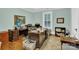 This is an office featuring neutral walls, dark wood furniture, and dark wood floors at 634 E Center Ave, Mooresville, NC 28115