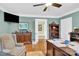 This is an office with neutral walls, dark wood furniture, a ceiling fan, and doorway view at 634 E Center Ave, Mooresville, NC 28115