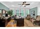 This is an office with neutral walls, dark wood furniture, lots of windows, and a ceiling fan at 634 E Center Ave, Mooresville, NC 28115