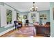This is an office with neutral paint, dark wood furniture, hardwood floors, and lots of natural light at 634 E Center Ave, Mooresville, NC 28115