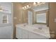 Bathroom featuring a double vanity, large mirror, and modern fixtures, offering both style and functionality at 6614 Truman St, Indian Trail, NC 28079