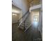 Inviting entryway with staircase and elegant chandelier, and hardwood style floors in the foyer and open living space at 6614 Truman St, Indian Trail, NC 28079
