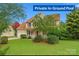 Charming two-story home with red shutters, covered porch and manicured lawn at 6614 Truman St, Indian Trail, NC 28079
