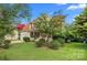 Charming two-story home featuring a well-manicured lawn, red shutters, and a welcoming front porch at 6614 Truman St, Indian Trail, NC 28079